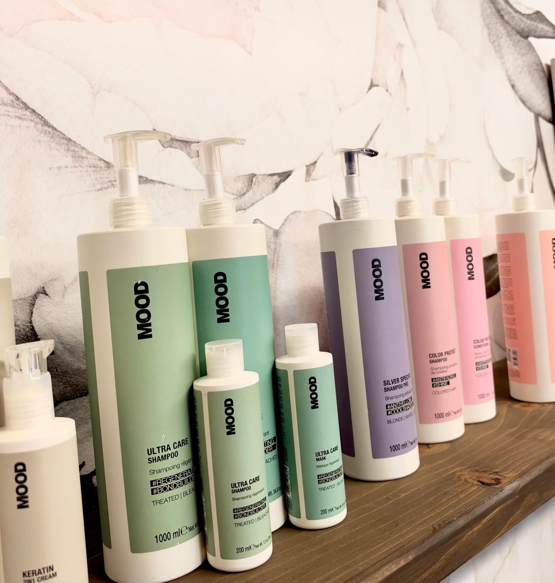 Mood professional shampoos, masks, and treatments on the shelf at Atria Beauty Collective.